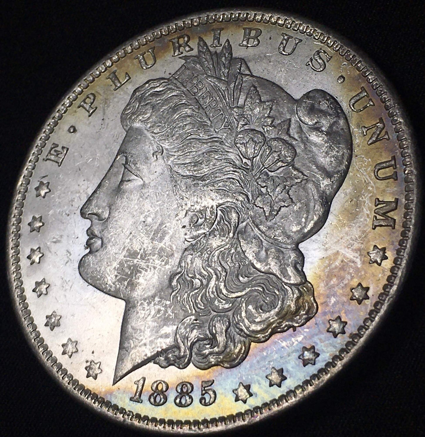 1885-O Morgan Silver Dollar - Rainbow Toning on Rim